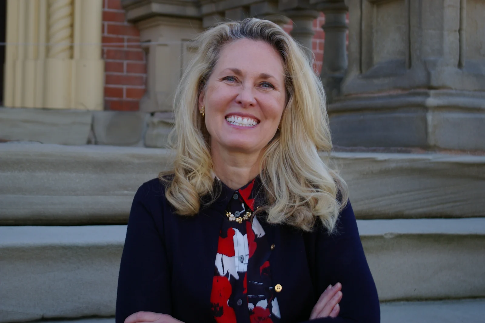 Photo of Attorney Adrienne Iddings outside the historical law office building in Adrian MI